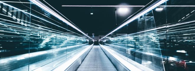 gray conveyor between glass frames at nighttime